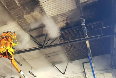 Industrial steam cleaner cleaning a building with damaged smoke. Buy the best steam cleaning machine to remove the smoke damage
